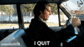 a man in a suit and tie is driving a car and says i quit