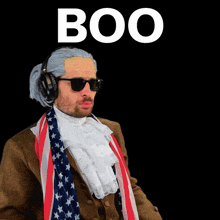 a man wearing headphones and sunglasses is standing in front of a black background that says boo