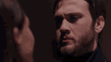 a man and a woman are looking at each other