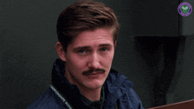 a man with a mustache is wearing a jacket that says championships with wimbledon on it