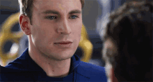 a close up of a man 's face looking at another man