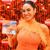 a woman holding up a package of seara levissimo