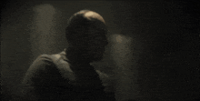 a man in a suit says it should have been me in a dark room