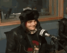 a man is sitting in front of a microphone in a radio studio .