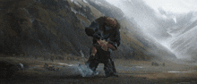 a painting of a man holding another man in front of mountains