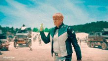 a man in a superman costume is holding a green object