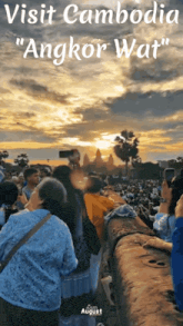 a group of people are taking pictures of the sunset at angkor wat in cambodia