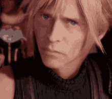 a man with blonde hair and blue eyes looks at the camera with a serious look on his face