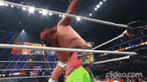 a man in a wrestling ring with the words clideo.com on the bottom right