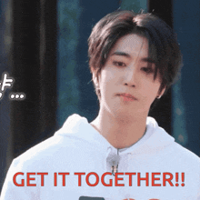 a young man in a white hoodie says get it together in red