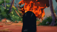 a cartoon character is standing in front of a fire in the woods .