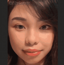 a close up of a woman 's face with @akolaney written on the bottom