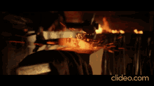 a close up of a fire with the website clideo.com in the lower right corner
