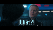 a man is talking to another man with the words what written on the screen