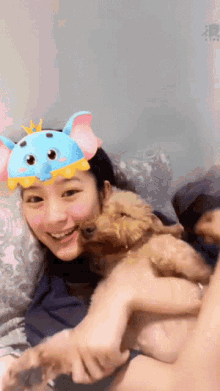 a woman wearing an elephant mask is holding a small dog