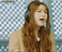 a woman wearing headphones with the words honeycam.org on the bottom left