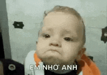 a baby is making a funny face and making a funny face .