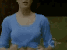 a woman in a blue shirt is on a lifetime movie network advertisement