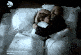 a man is hugging a woman in a bed with the words oyle bir cecer zaman ki written on the bottom