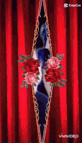 a woman 's face is behind a red curtain surrounded by roses
