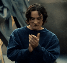 a man wearing a blue shirt is clapping his hands and the word kepler is visible in the corner