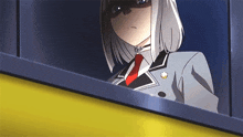 a woman in a suit and tie looks out a window