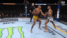 two men are fighting in a boxing ring sponsored by espn and monster