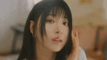a close up of a woman 's face with a slight smirk on her face