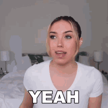 a woman in a white shirt says " yeah "