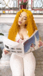 a woman with yellow hair is reading a magazine with the word unlimited on it