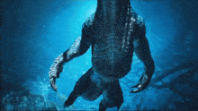 a monster is swimming in the ocean with its claws visible