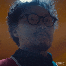 a close up of a man 's face with a netflix logo on the bottom right