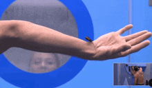a man 's arm is shown in front of a blue circle