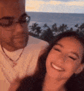 a man and a woman are posing for a picture and smiling
