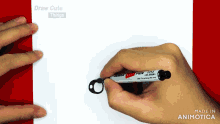 a person is holding a zebra pen and drawing on a piece of paper