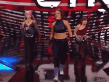 a group of women are standing on a stage in front of a sign that says starr .