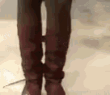 a person is wearing a pair of brown boots .