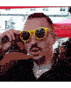 a man wearing a pair of yellow sunglasses adjusts his glasses