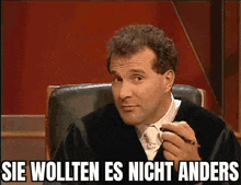 a man sitting in a chair with the words sie wollten es nicht anders written on the bottom