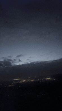a dark night sky with a few clouds in it