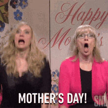 two women are standing in front of a sign that says happy mothers day