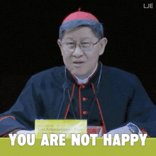 a man in a cardinal 's robe says " you are not happy "
