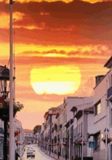 a street with a sunset in the background and a sign that says crosswalk