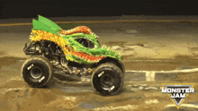 a monster jam monster truck is driving on a track