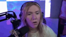 a woman wearing headphones is talking into a microphone .