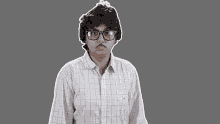 a man wearing glasses and a plaid shirt has his mouth open