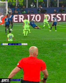 a soccer game is being shown on espn deportes and the referee is wearing a red shirt