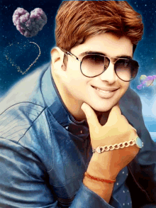 a man wearing sunglasses and a bracelet on his wrist smiles