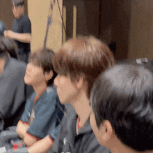 a group of people are sitting in a room with their arms crossed .