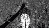 a black and white drawing of a man covering his face with his hands .